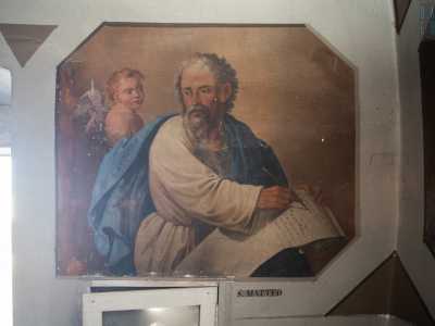 Pi� in basso, alla destra della porta, � infine raffigurato San Matteo mentre scrive su una pergamena il suo Vangelo